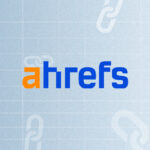 Text "ahrefs" with the "a" in orange and the rest in blue, on a light blue background with chain link icons.